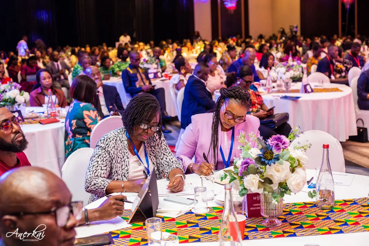 Delegates taking notes during a summit session