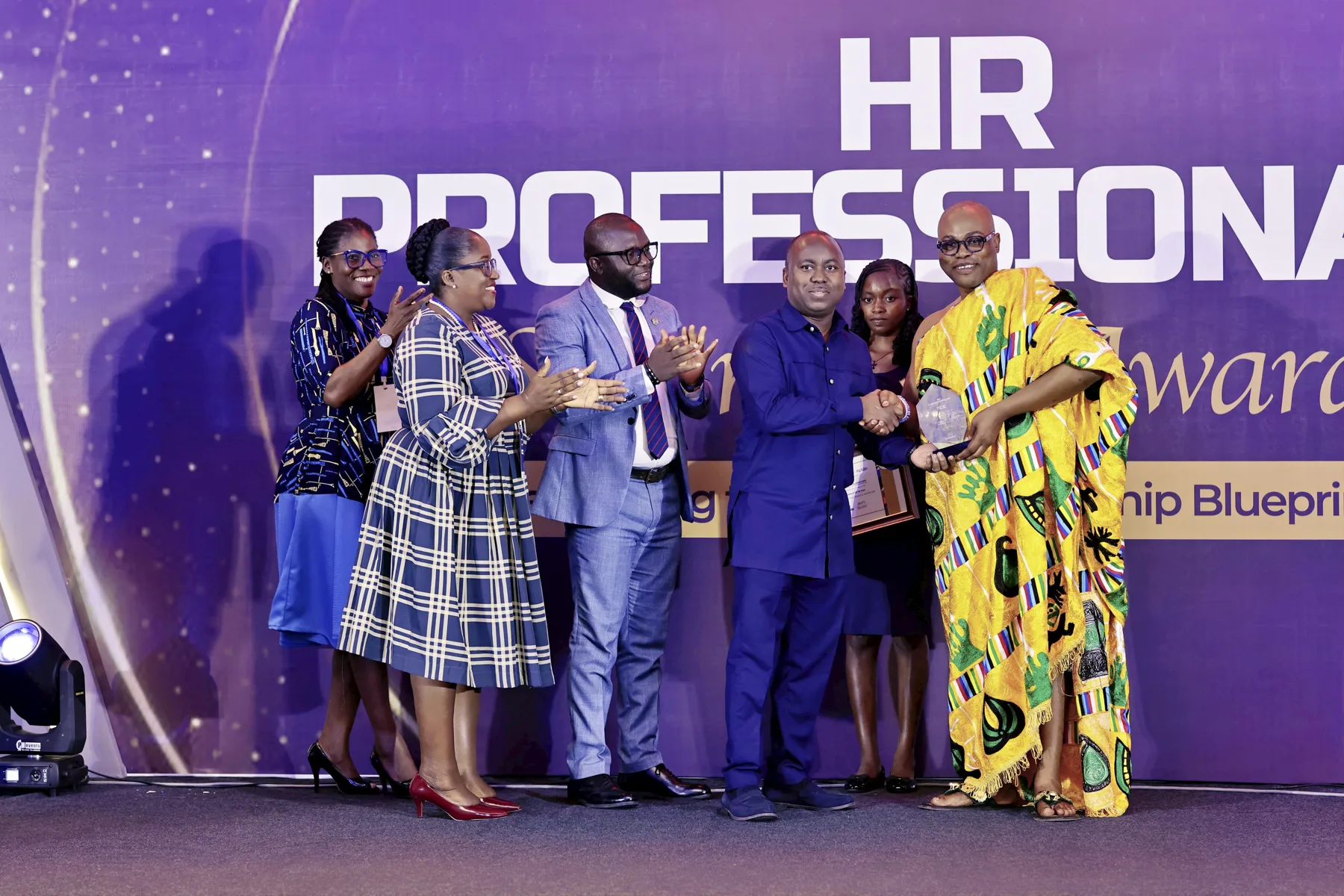 An award being presented on stage at the HR Professionals Summit & Awards
